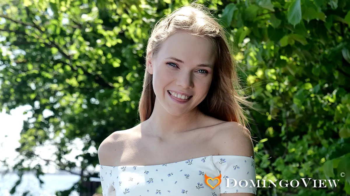 Luise Wixx posing by the river in soft sunlight revealing natural beauty